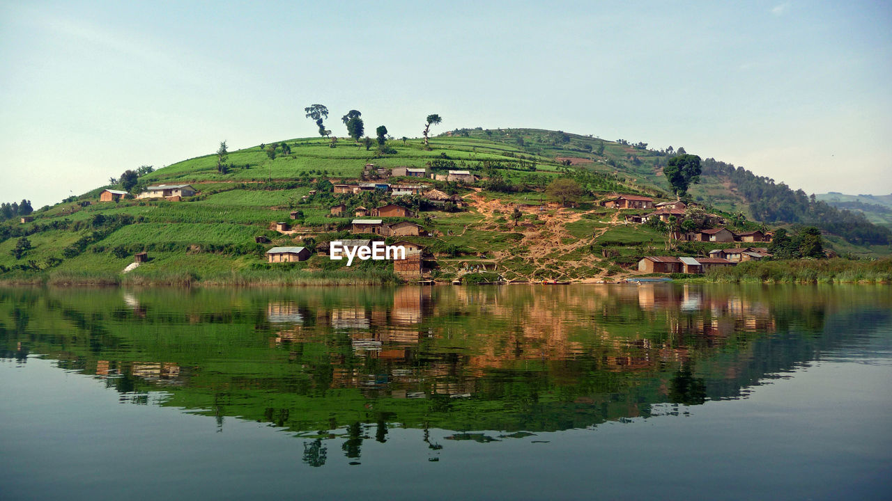 Scenic view and reflection of lake bunyonyi against sky