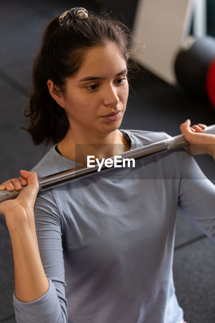 portrait of young woman exercising in gym at home