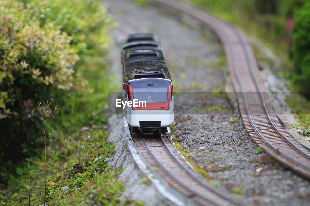 TRAIN ON RAILROAD TRACK BY ROAD