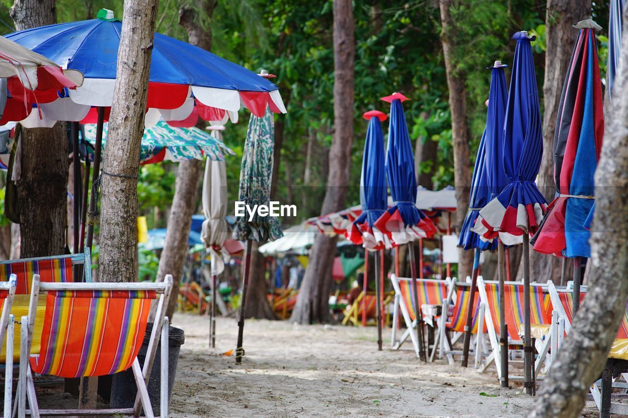 MULTI COLORED FLAGS HANGING ON CHAIRS AT OUTDOOR CAFE