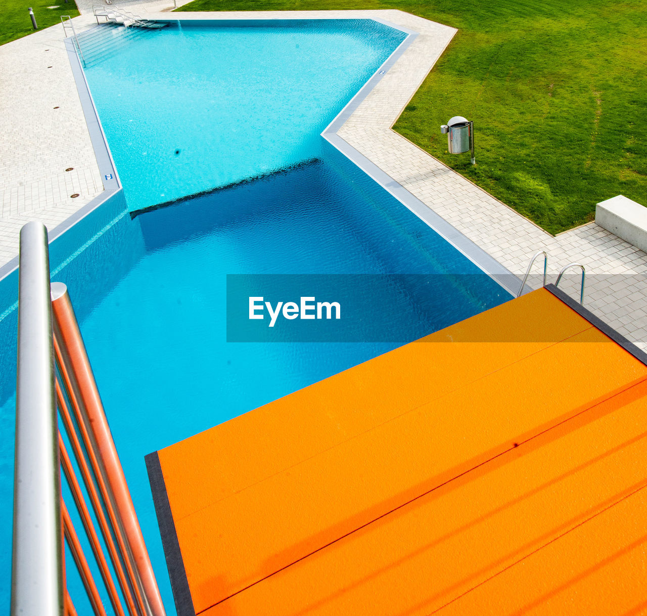 HIGH ANGLE VIEW OF SWIMMING POOL BY WATER