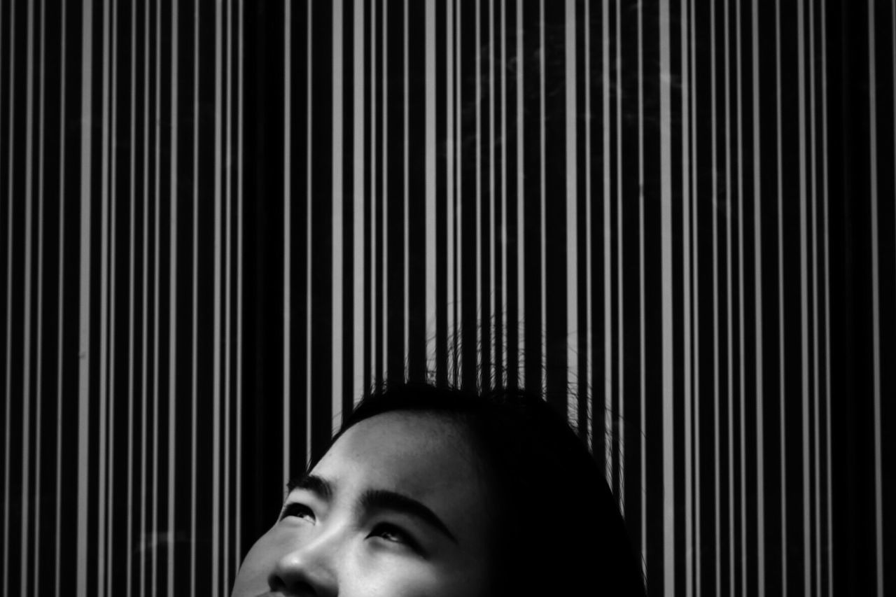 Cropped image of woman against patterned wall