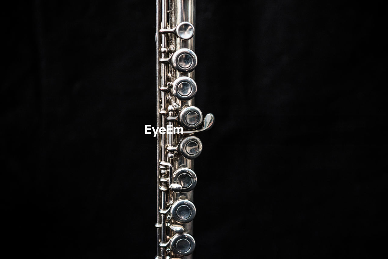 Close-up of flute against black background
