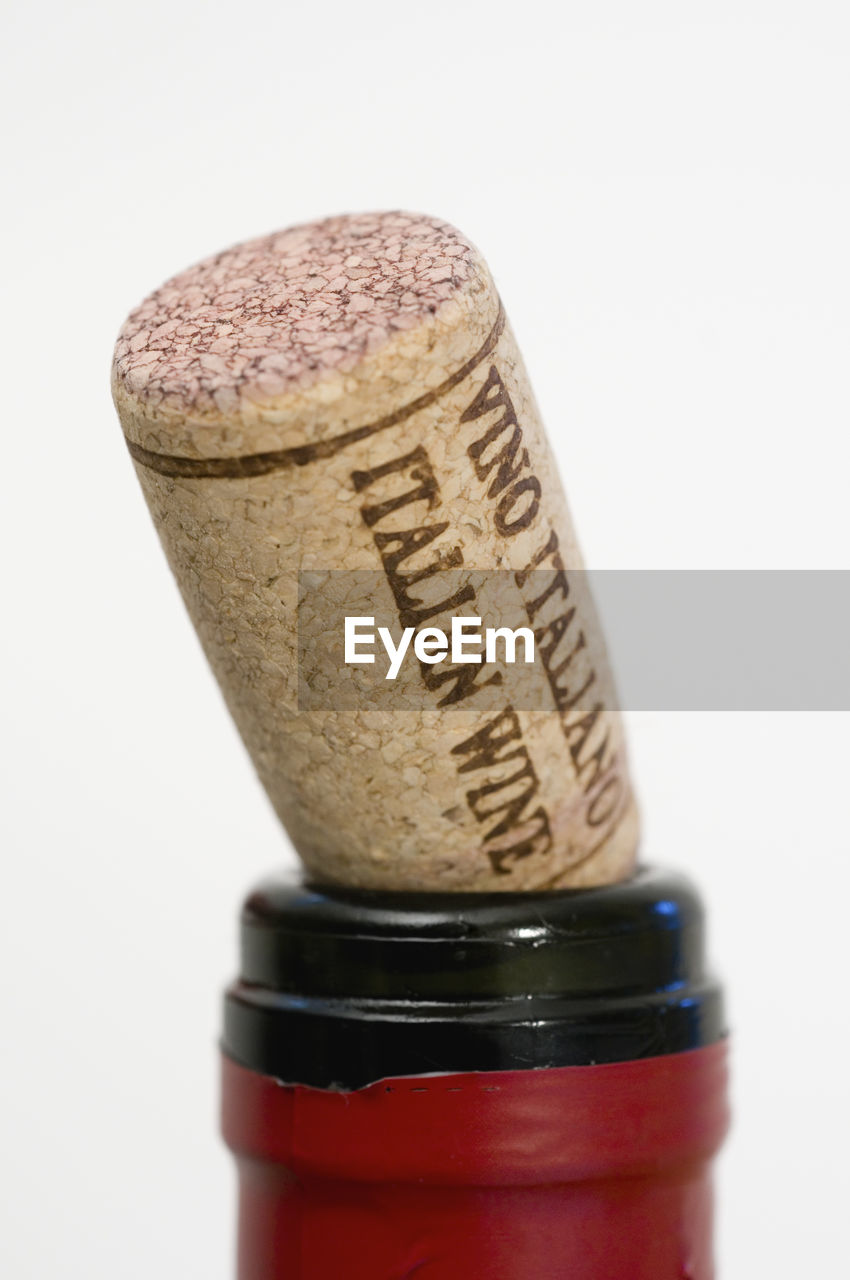 Close-up of cork on wine bottle against white background