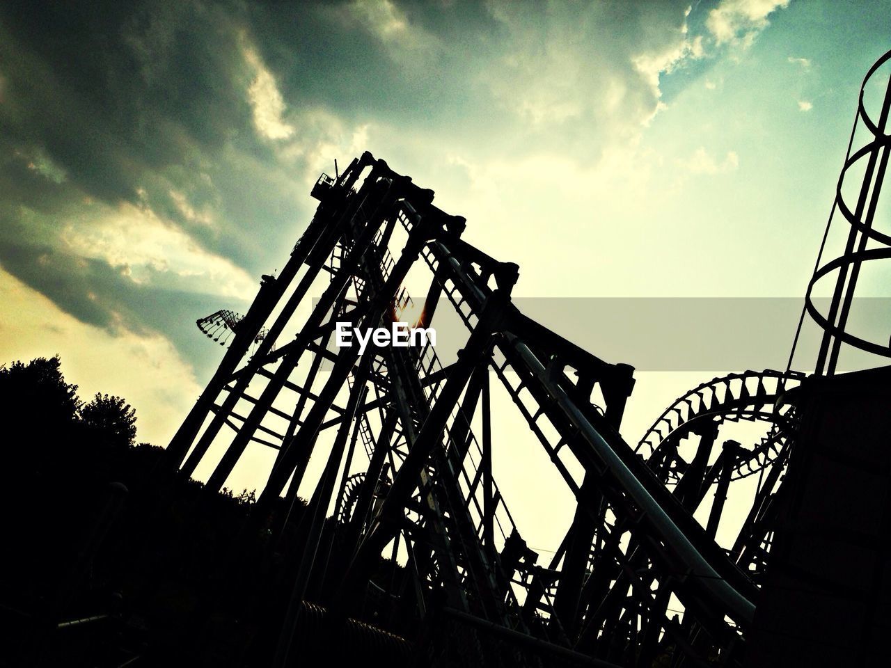 Low angle view of roller coaster against sky