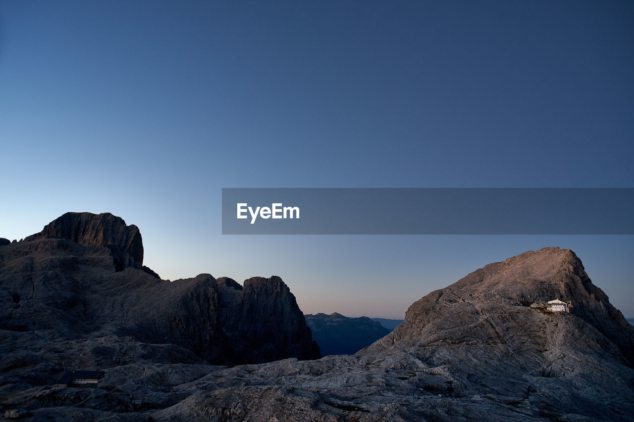 Rock formations against clear blue sky