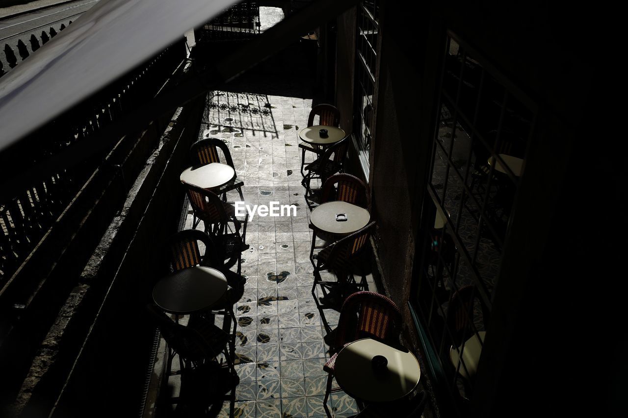 High angle view of chairs and tables at sidewalk cafe