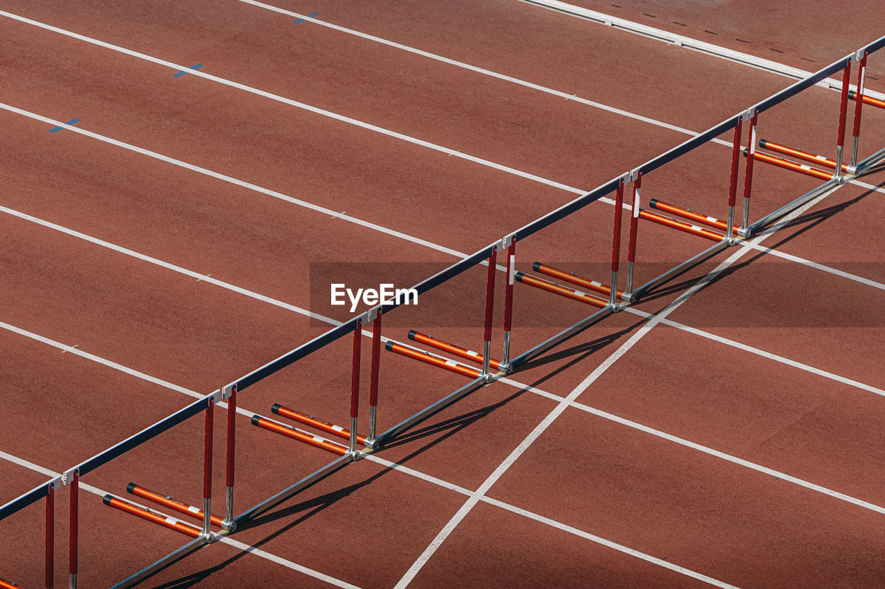 Hurdles for running 110 meters on red track of stadium