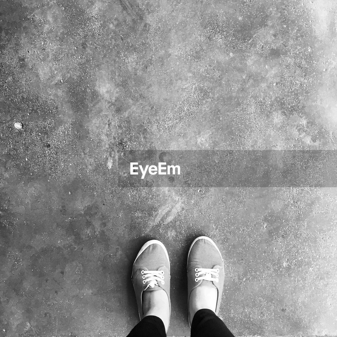 Woman standing on pavement