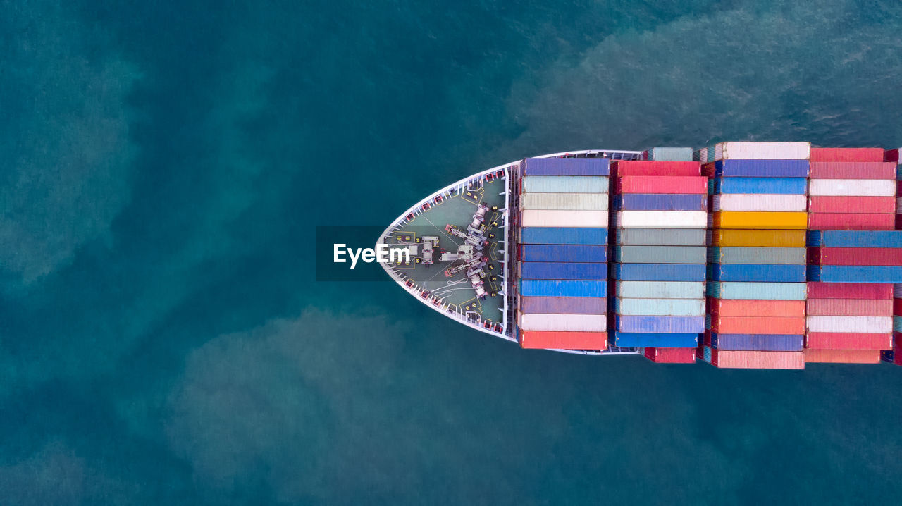 Aerial view of container ship sailing in sea