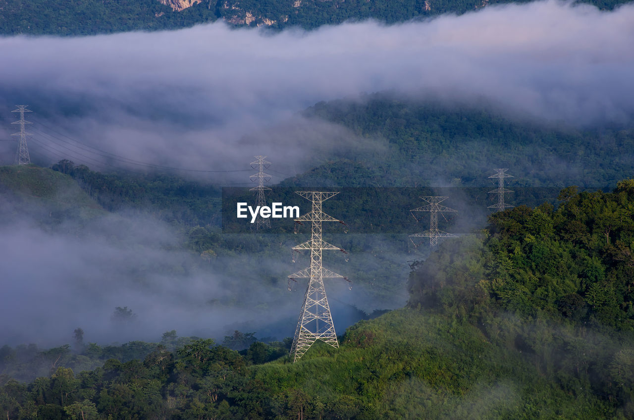 Aerial view of communications tower and trees against sky