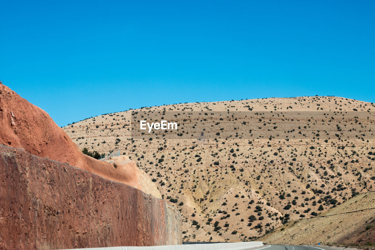 PANORAMIC VIEW OF DESERT AGAINST CLEAR BLUE SKY