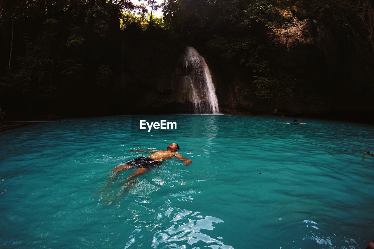 Man swimming at kawasan falls