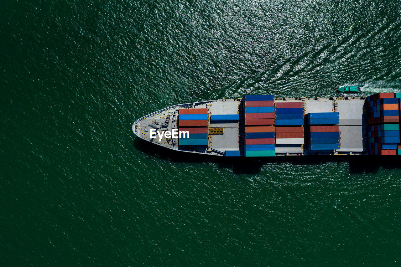 High angle view of shipping containers sailing on sea green