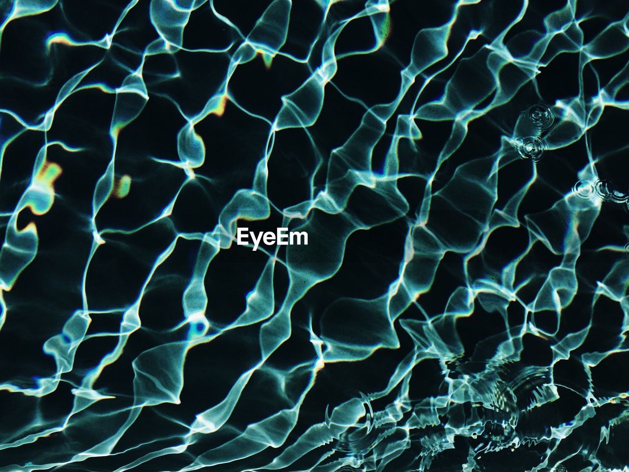 Full frame shot of glowing rippled water in swimming pool