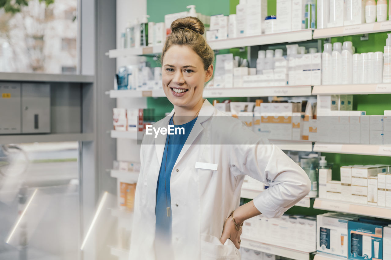 portrait of smiling female scientist standing in store