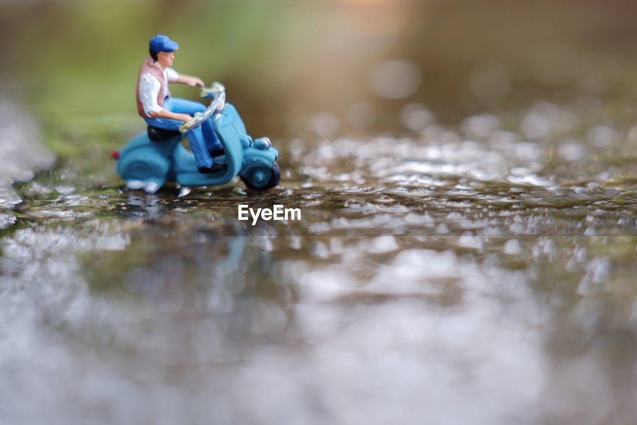SIDE VIEW OF TOY CAR IN WATER