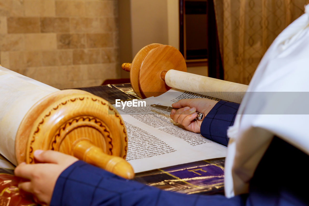 High angle view of person by torah at synagogue