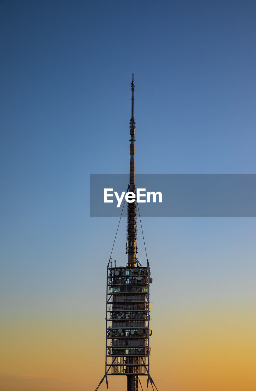 Low angle view of communication tower against clear sky
