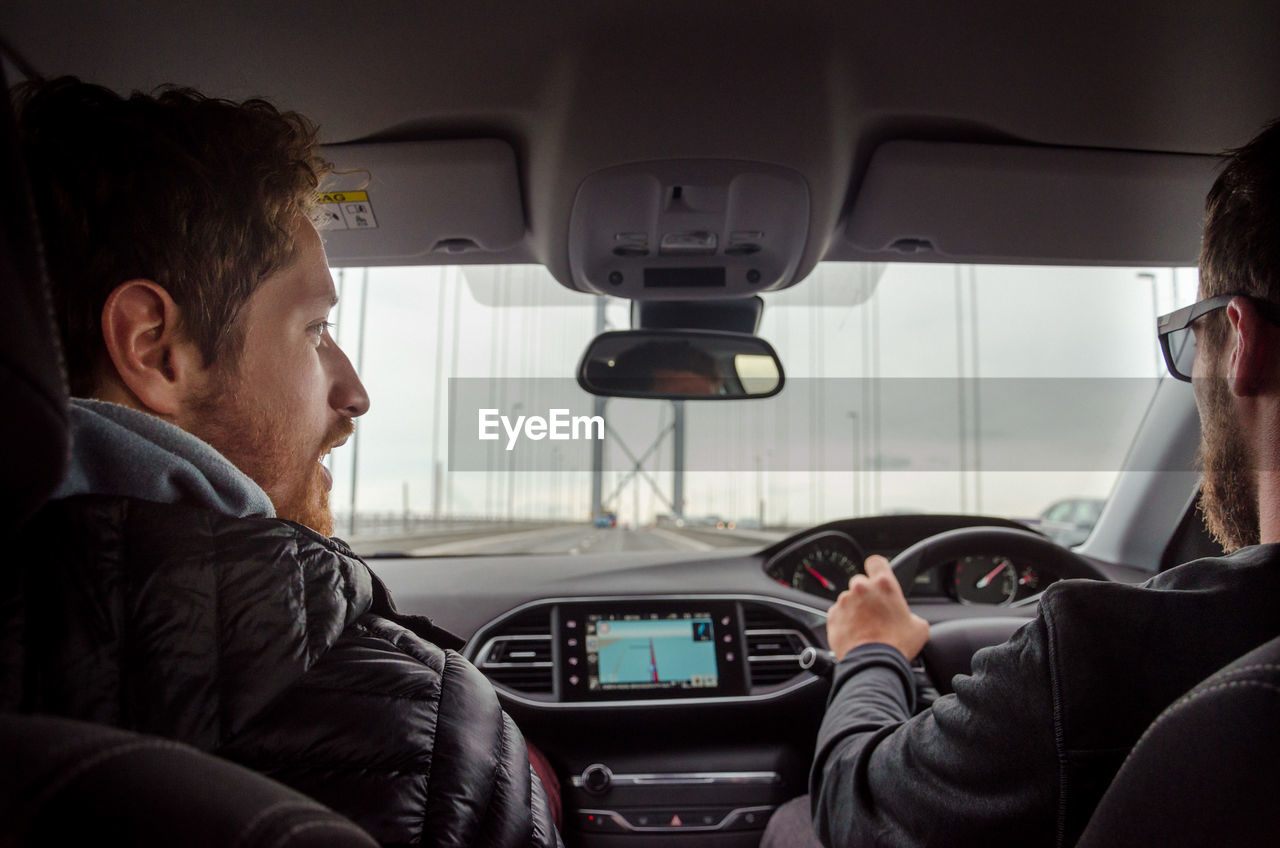 Rear view of men sitting in car