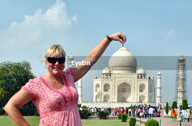 Optical illusion of mature woman holding taj | ID: 95347266