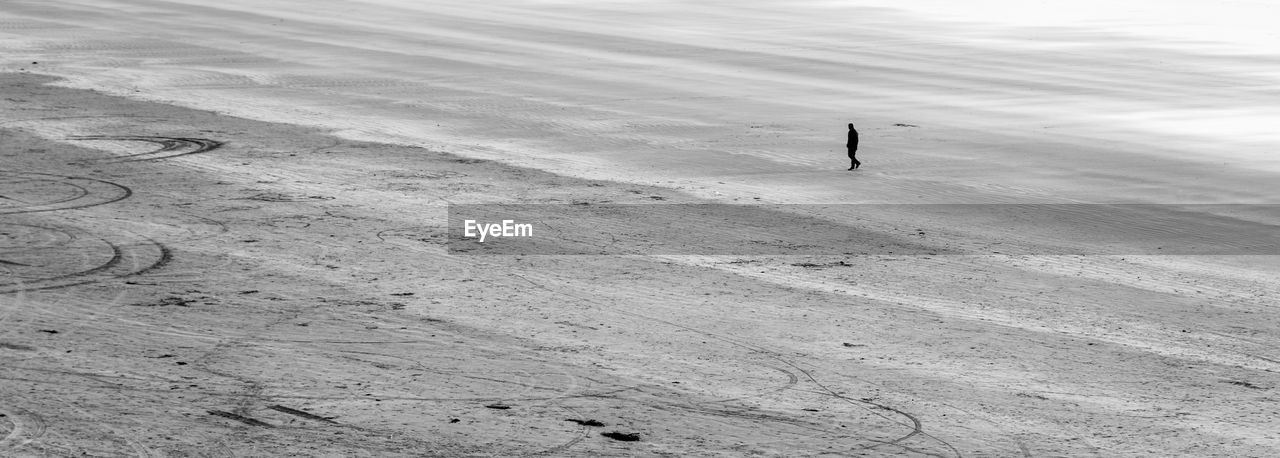 Man walking on barren field