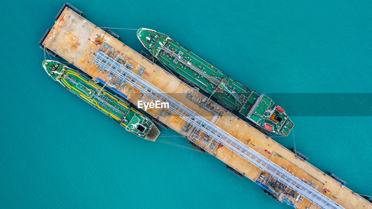 Aerial view of ship by pier over sea