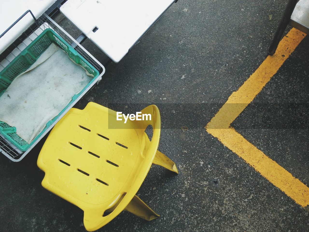 High angle view of chair and crate on road