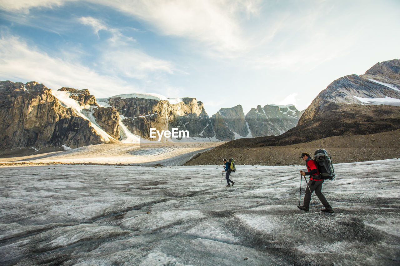 Side view of two mountaineers exploring auyuittuq national park