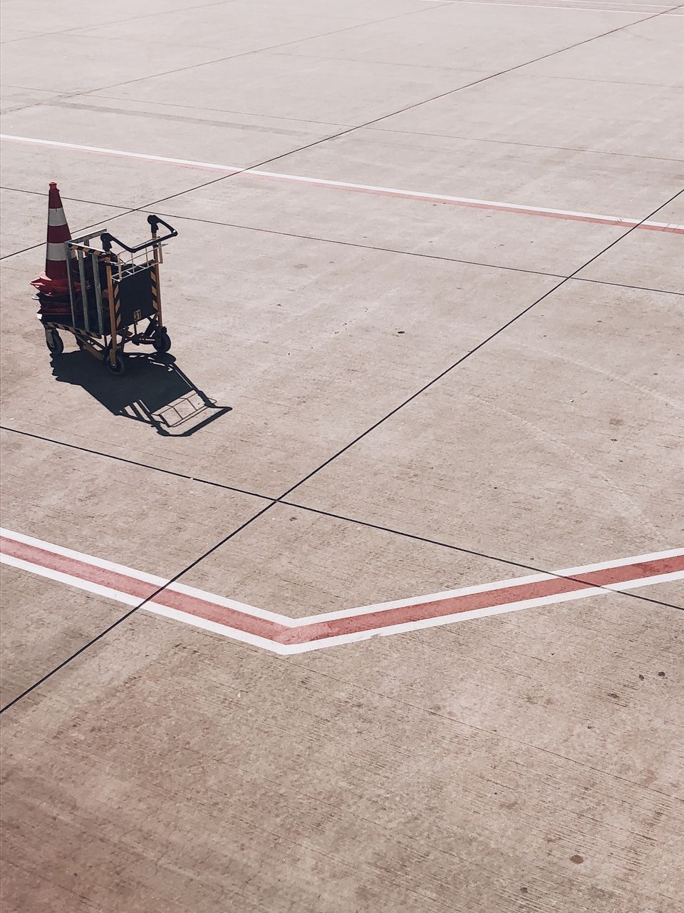 High angle view of luggage cart on airport runway