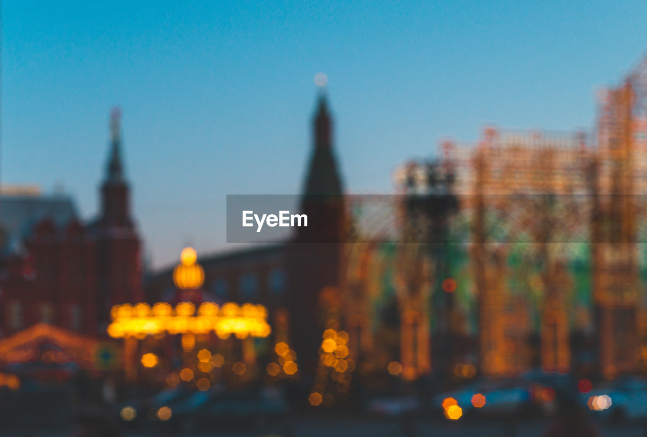 Defocused image of red square lit up at dusk. moscow