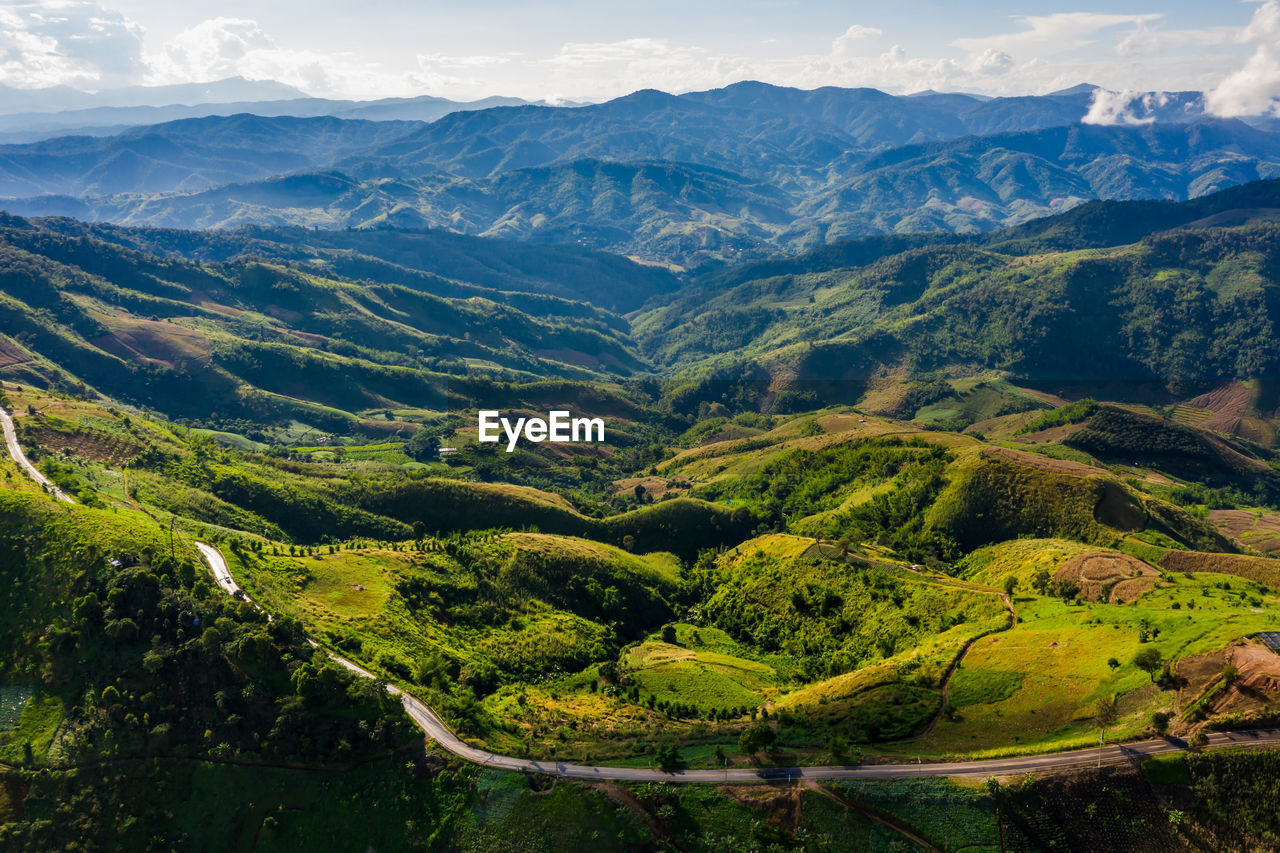 Natural reservoir dam in the valley in thailand aerial view from drone rain season at evening