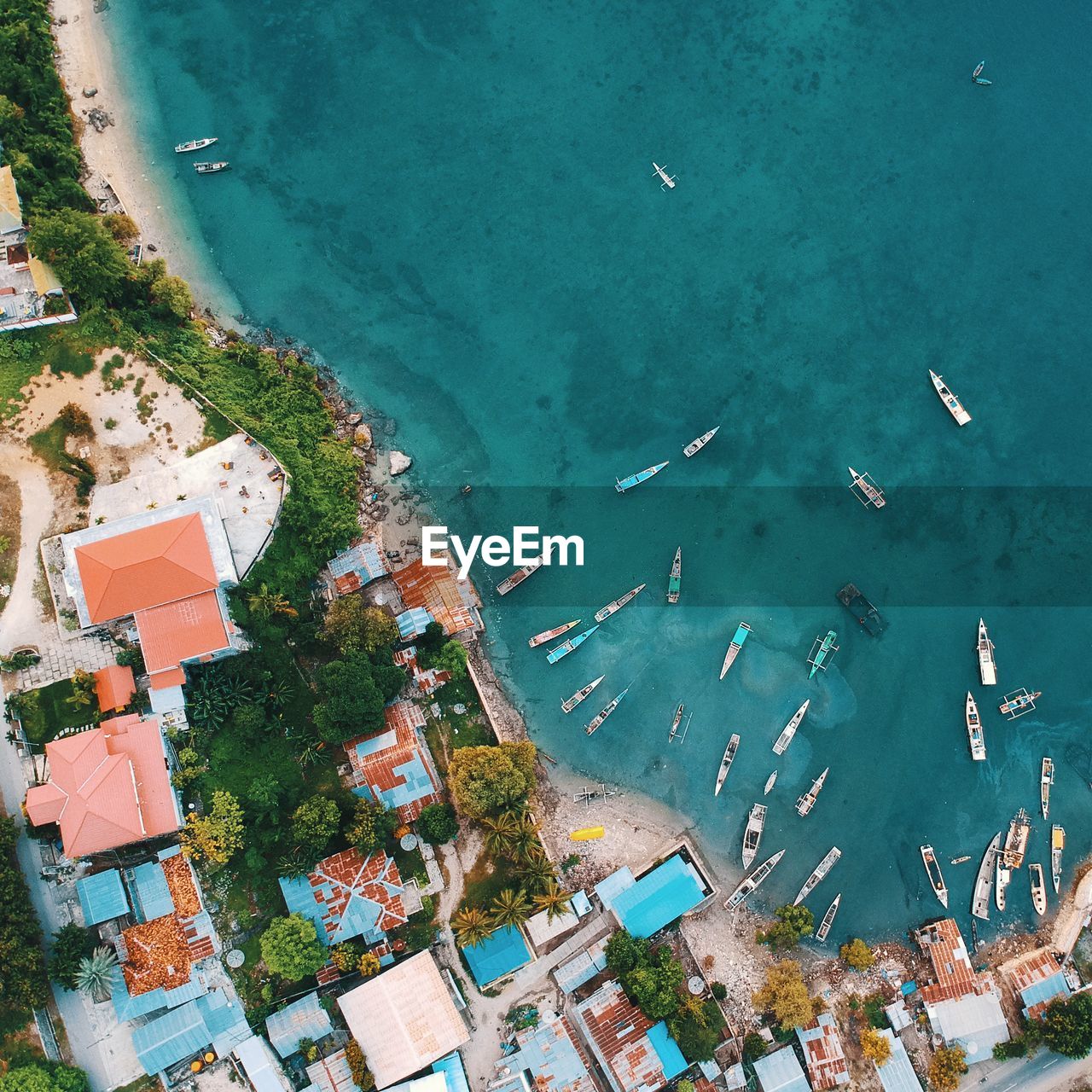 Aerial view of buildings by boats moored on sea