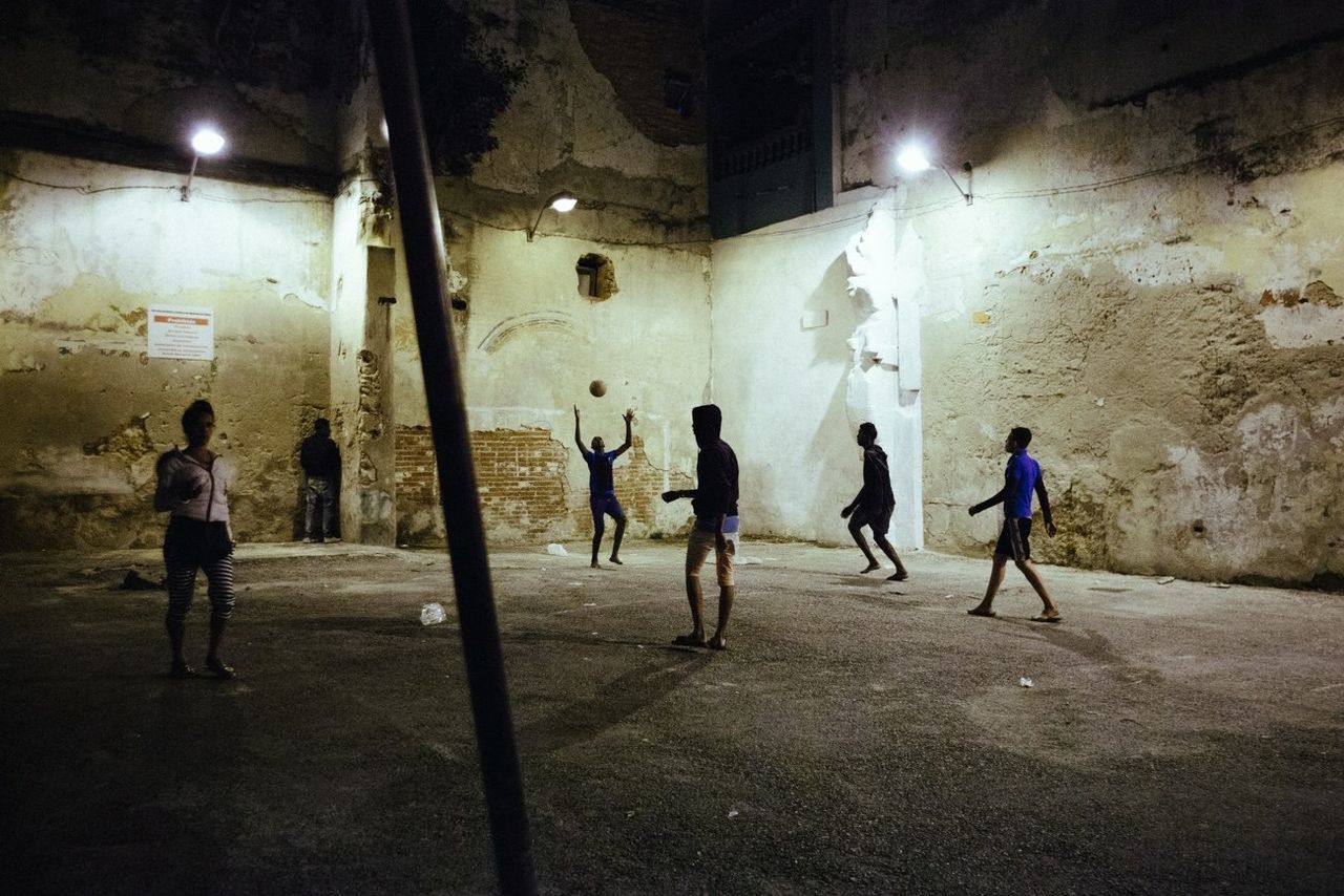 Men playing in abandoned building