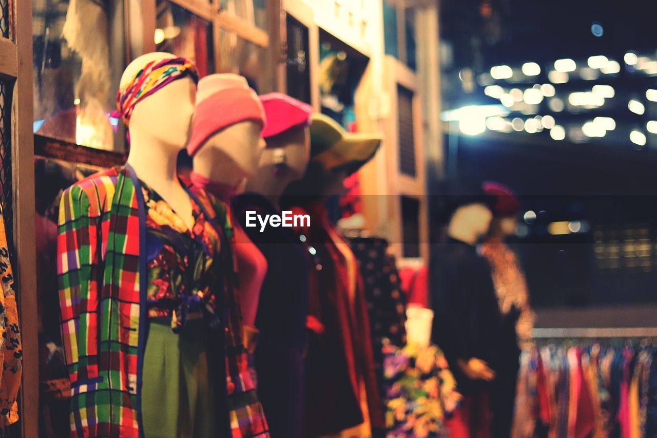 Mannequins wearing colorful dresses in clothing store