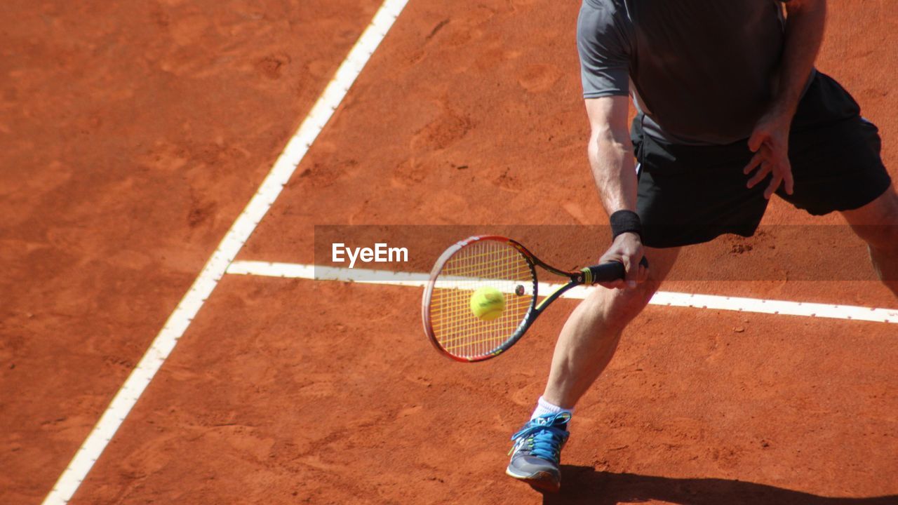 Low section of man playing tennis