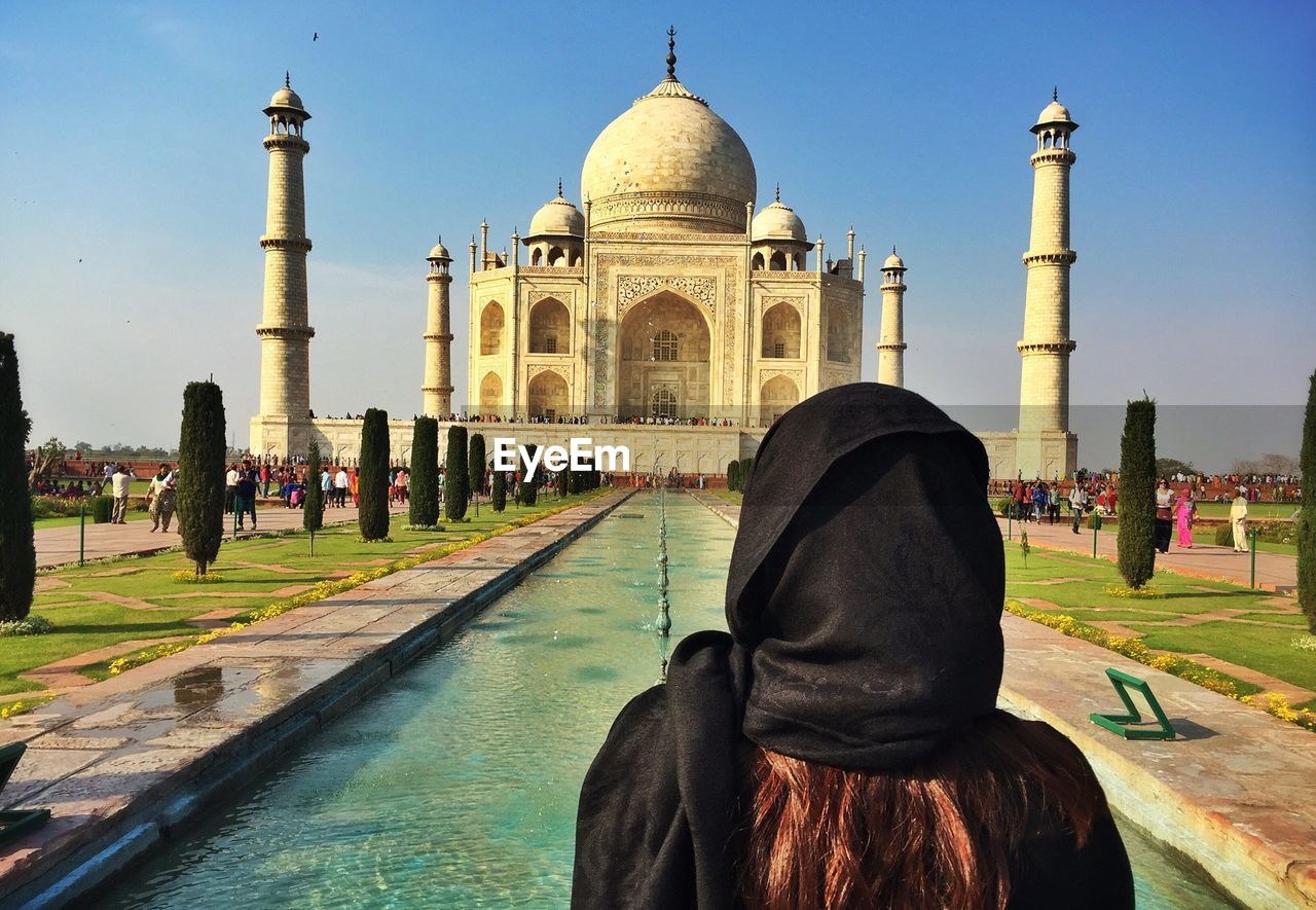 Rear view of woman looking at taj mahal