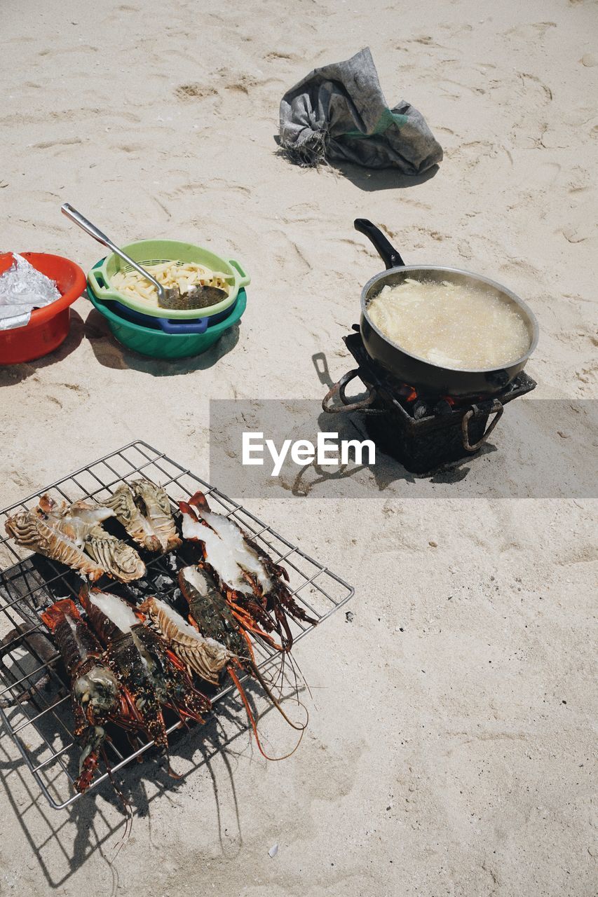 food, food and drink, sand, high angle view, beach, heat, land, no people, barbecue, nature, day, kitchen utensil, barbecue grill, container, outdoors, healthy eating, freshness, preparing food, wellbeing, dish