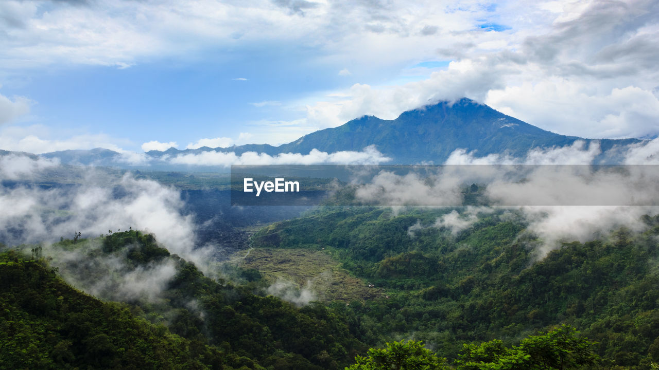 SCENIC VIEW OF CLOUDS OVER MOUNTAINS AGAINST SKY