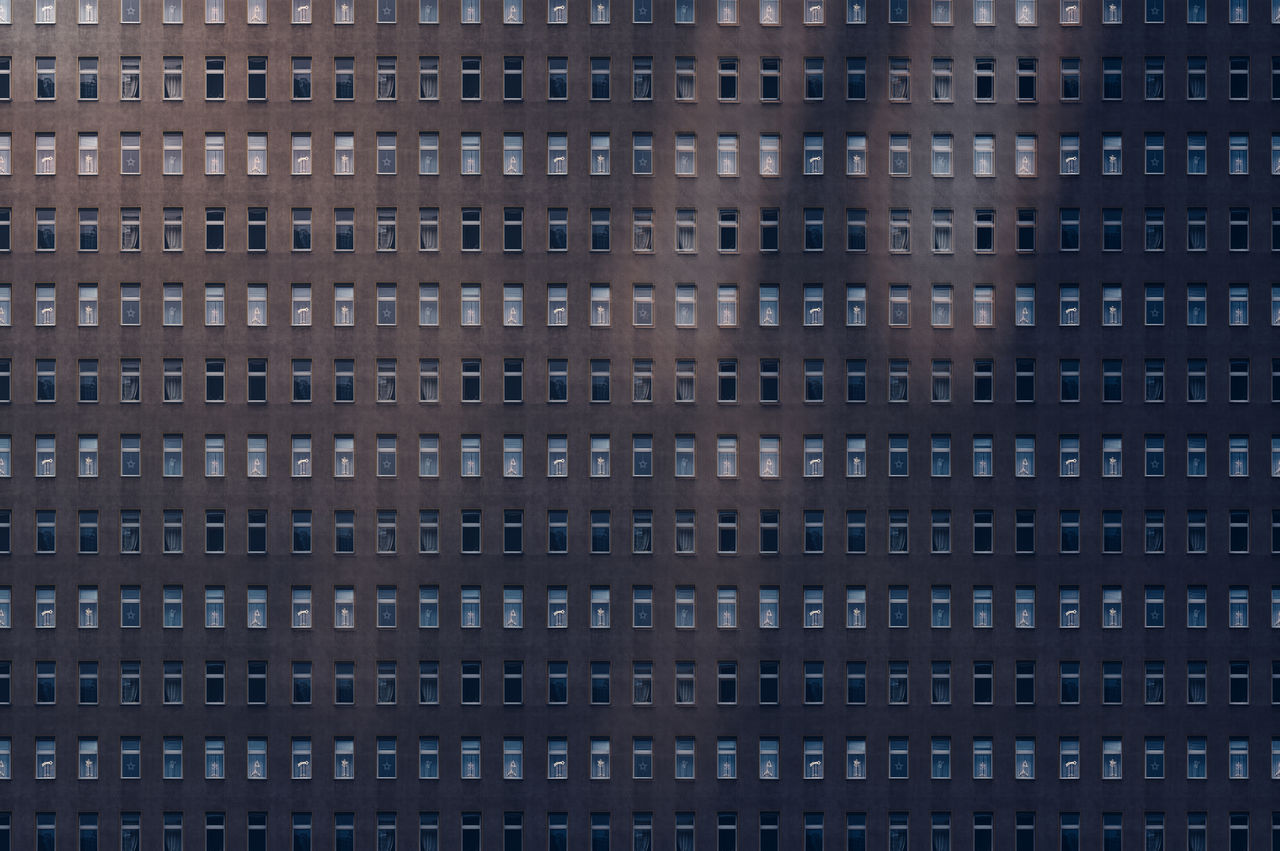 Architectural pattern, reflected light on a facade of a miserable house, with blur effekt