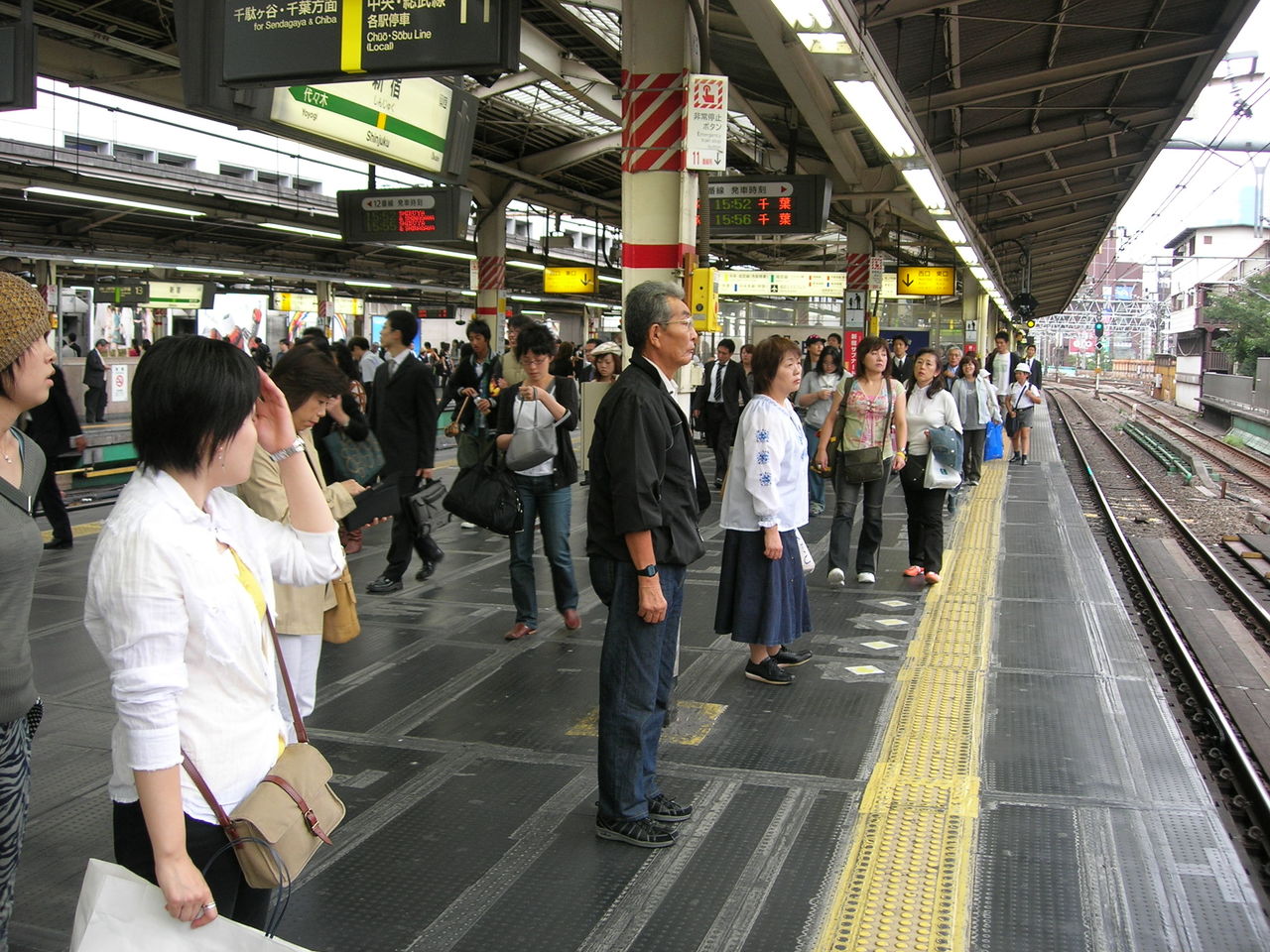 PEOPLE WAITING AT RAILROAD STATION