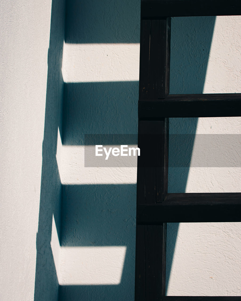 Shadow of ladder on wall