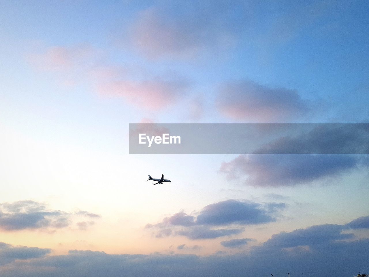 Low angle view of airplane flying against sky