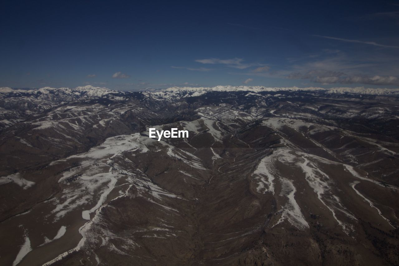 AERIAL VIEW OF SNOWCAPPED MOUNTAINS