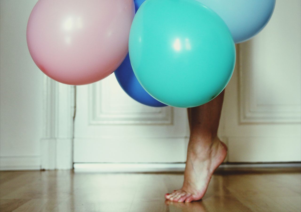 Low section of woman with balloons