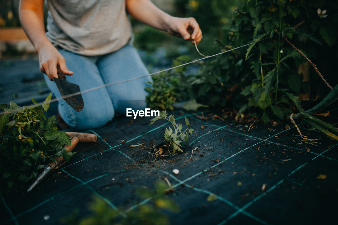 Low section of woman gardening