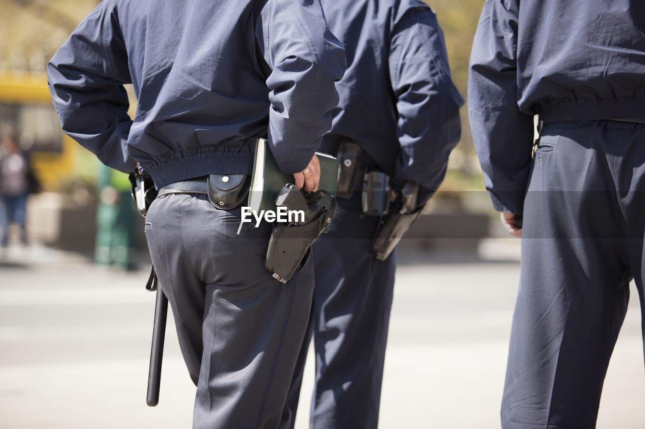 Rear midsection of police force on street