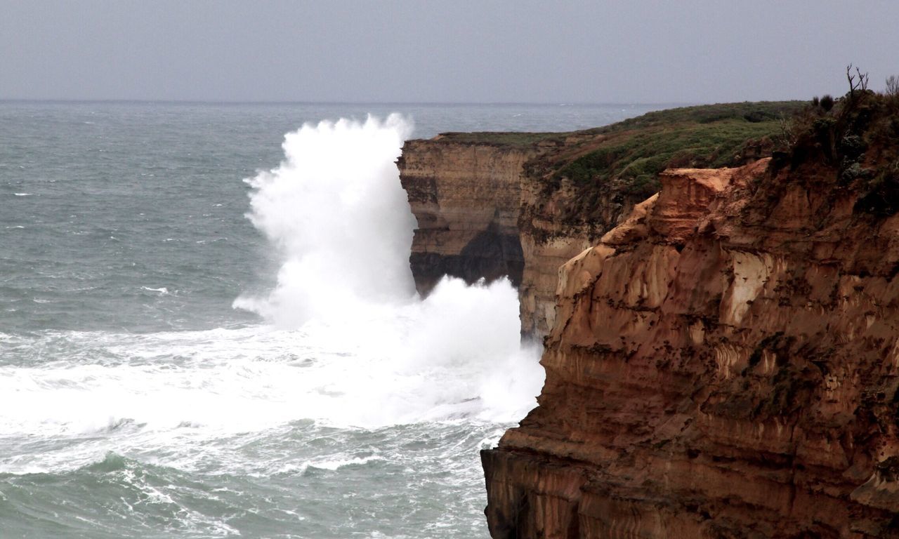 Sea waves splashing on cliff