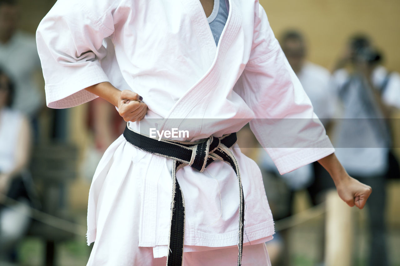 Midsection of child practicing karate