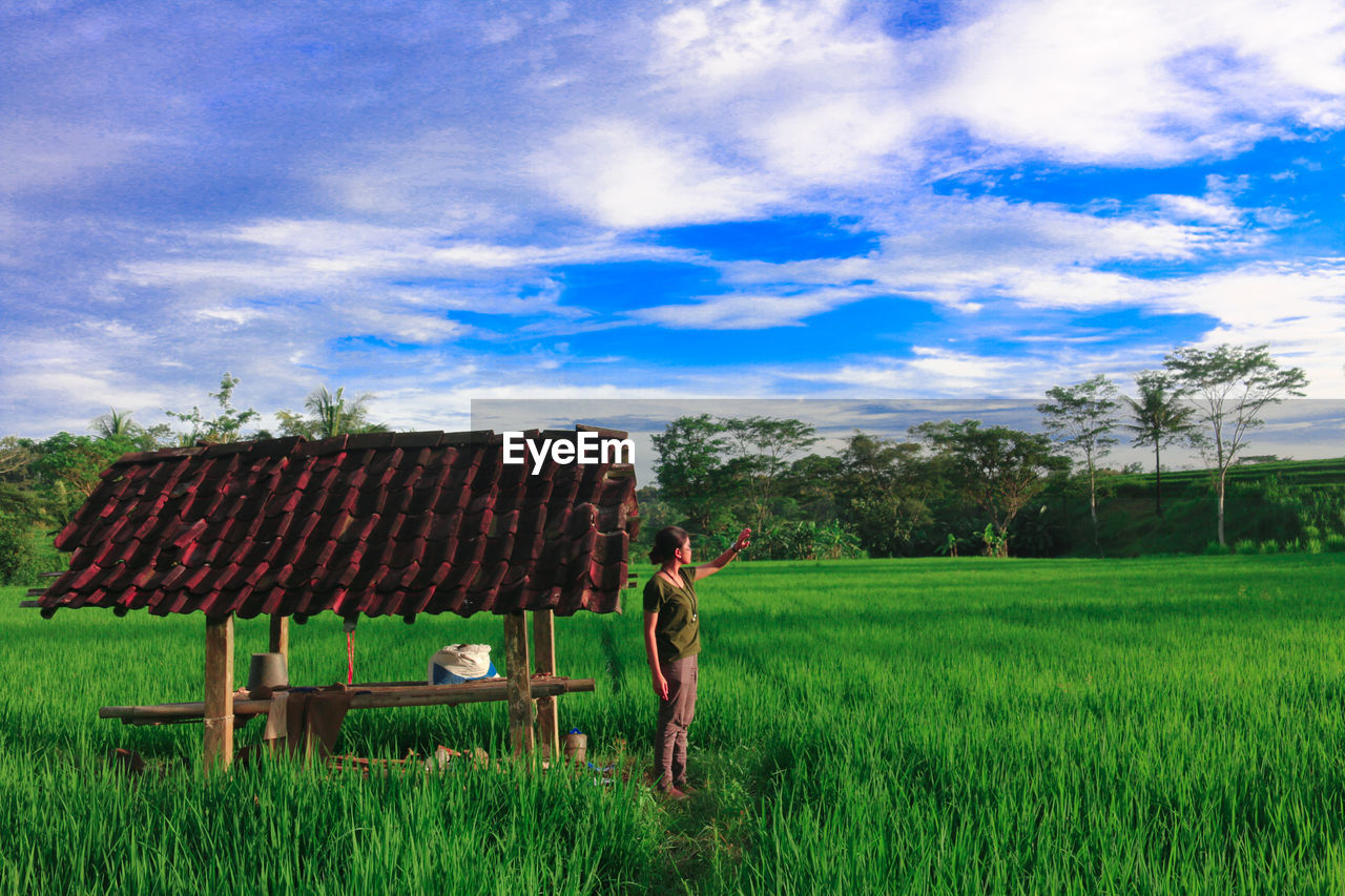 Full length of man on agricultural field against sky